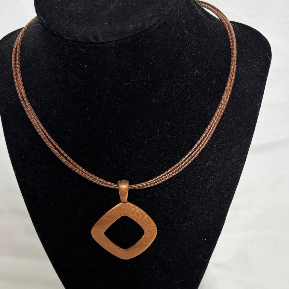 Premier Designs Ember Necklace copper tone geometric pendant on a leather cord